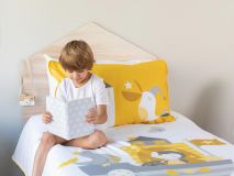Purdy the Penguin Organic Kids Bedding featuring a child reading a book